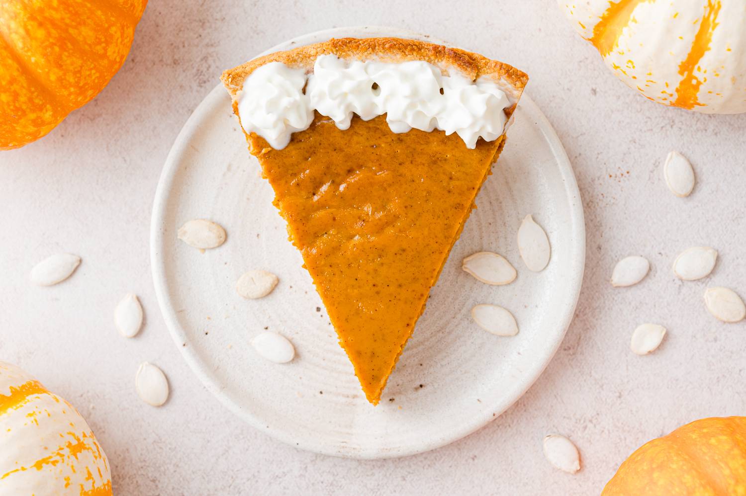Pumpkin pie on a white plate.