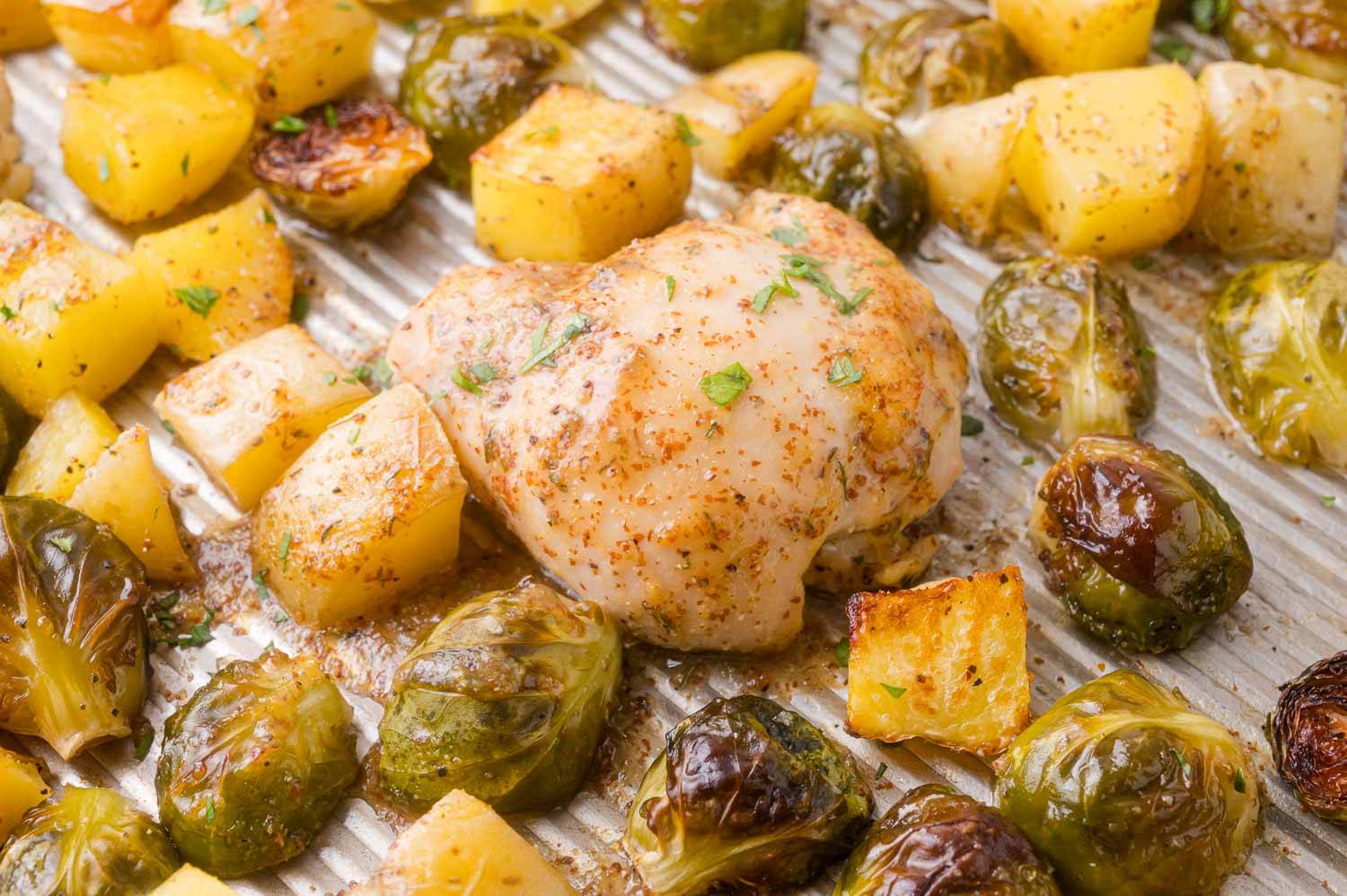Sheet pan with a mustard glazed chicken thigh, Brussels sprouts and potatoes. 
