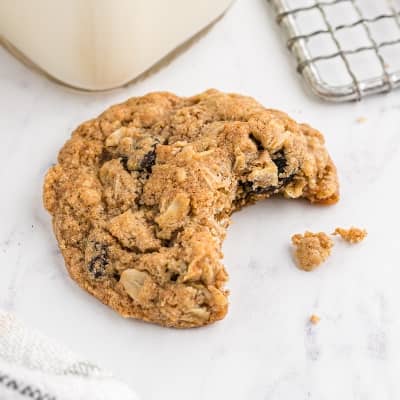 Oatmeal raisin cookie with a bite out of it.