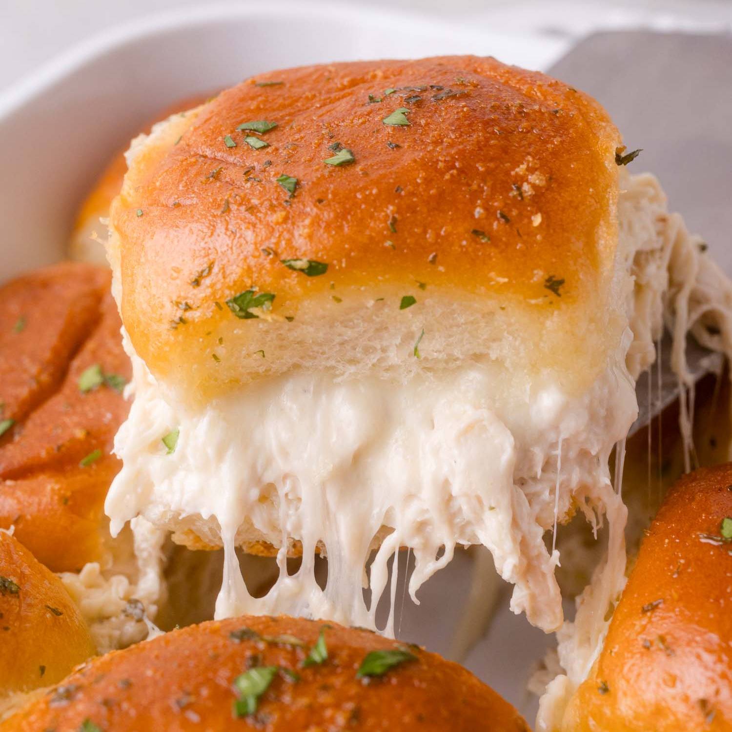 Chicken ranch slider being lifted out of pan with others.
