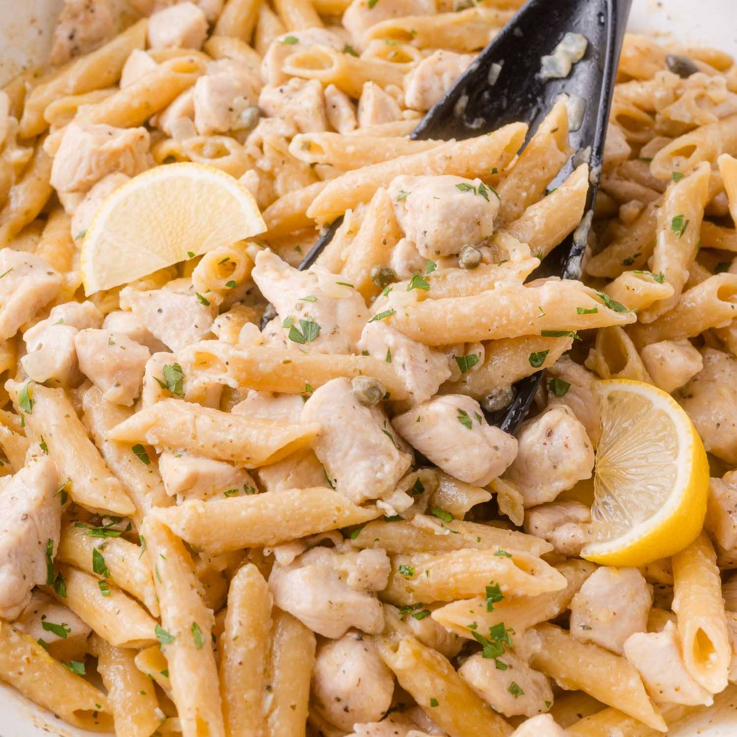 Chicken piccata pasta, with chicken, penne, and fresh herbs.