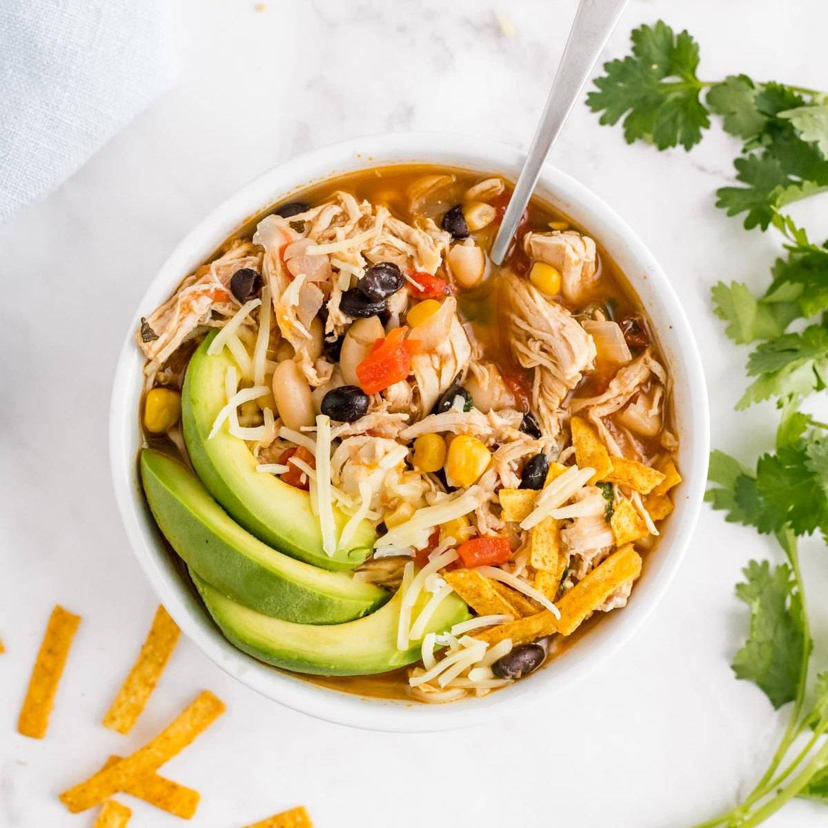 White chicken chili topped with avocado.