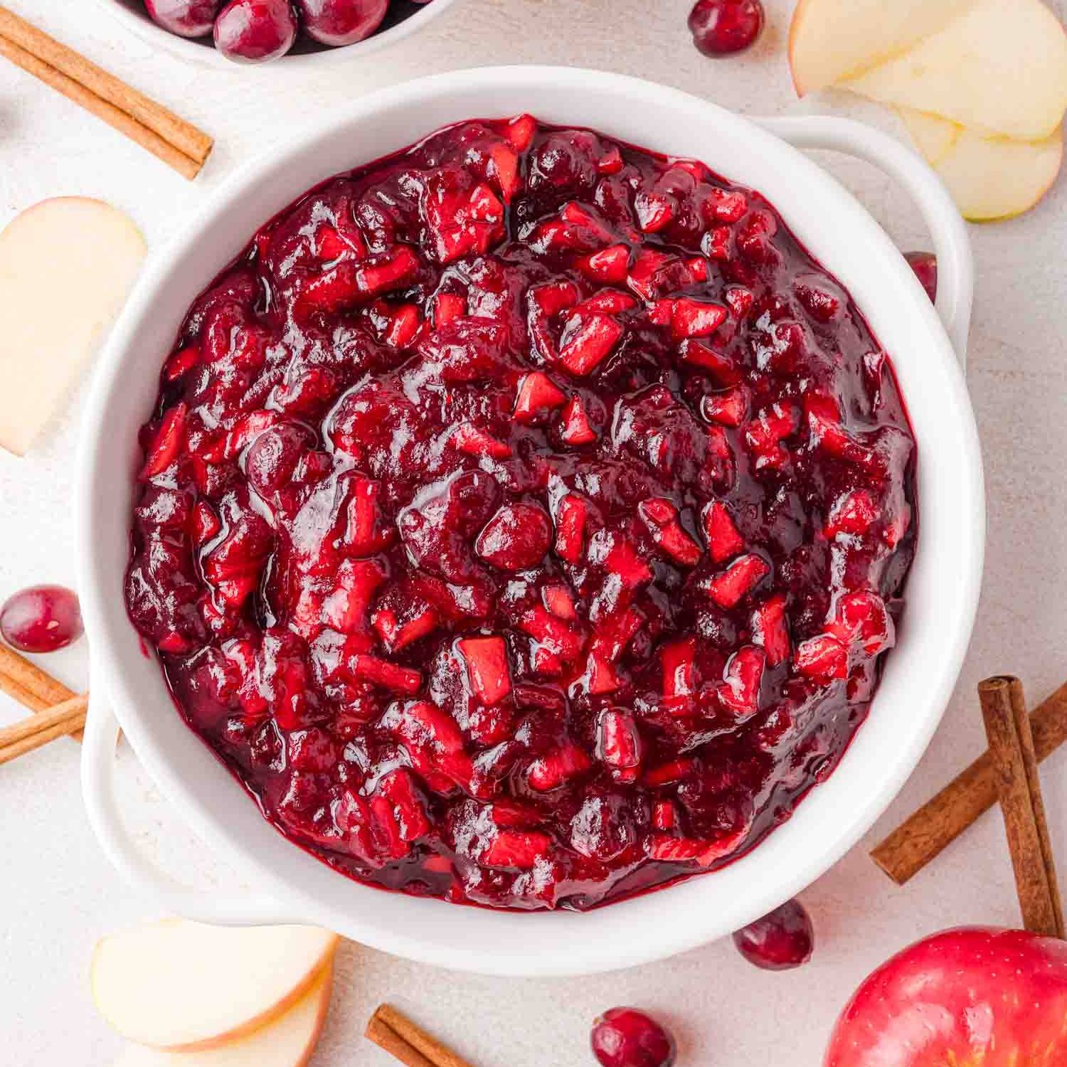 Cinnamon apple cranberry sauce in a white bowl.