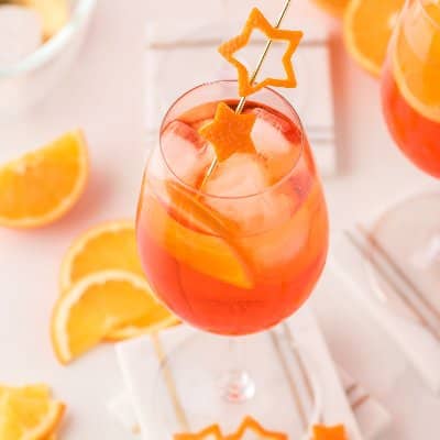 Aperol spritz with orange peel garnish.