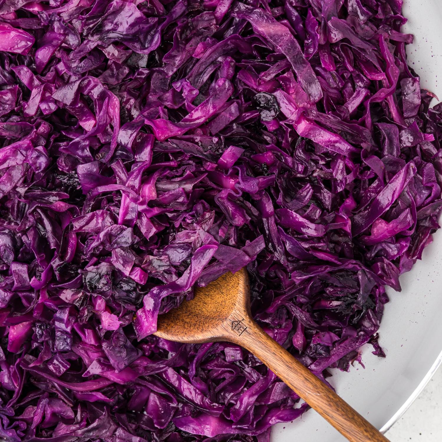 Sautéed red cabbage with a wooden spoon.
