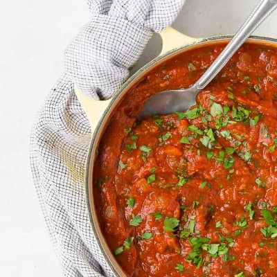 Spaghetti sauce in pale yellow pan.