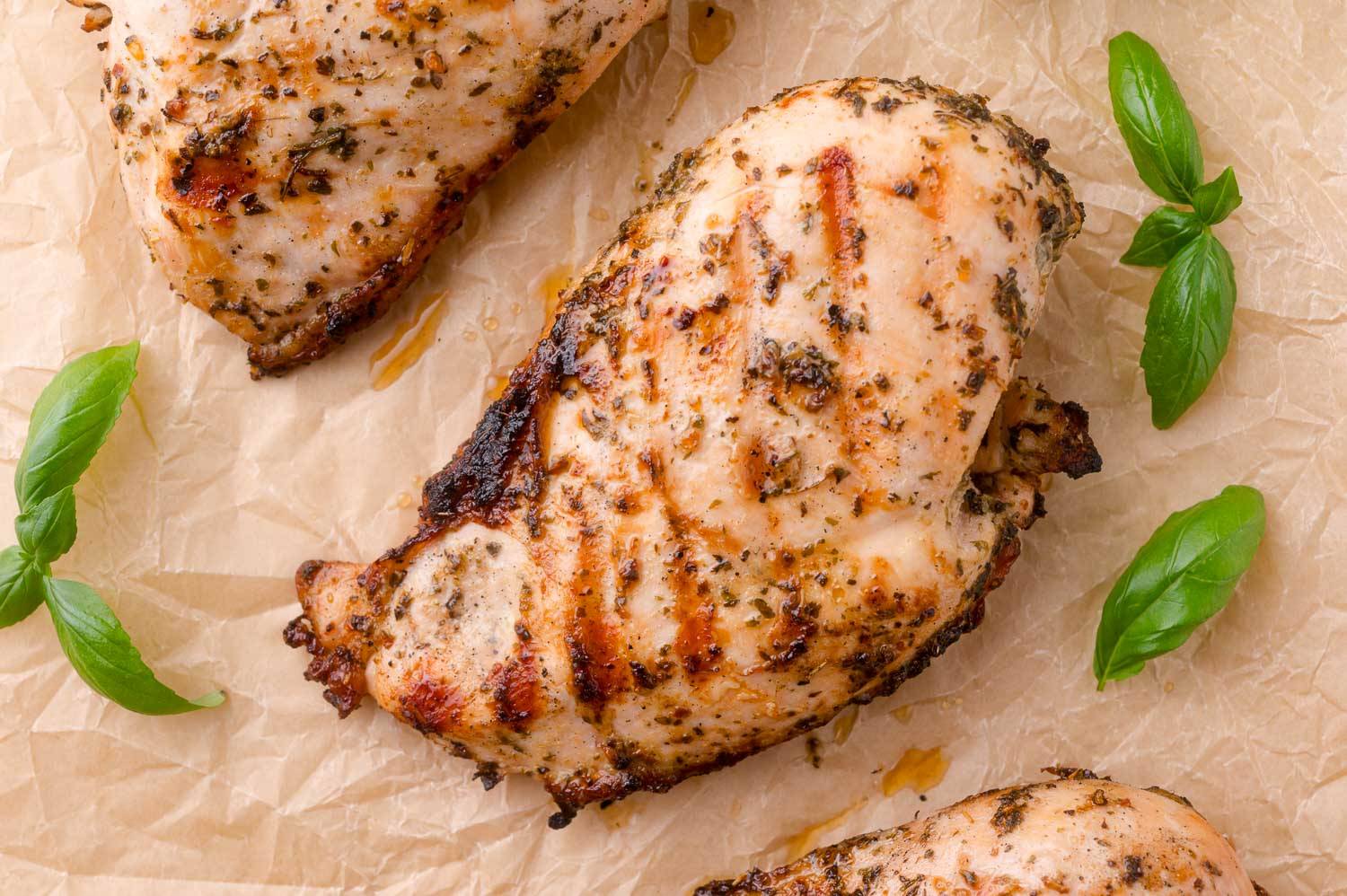 Grilled chicken that has seasonings on it from an Italian chicken marinade.