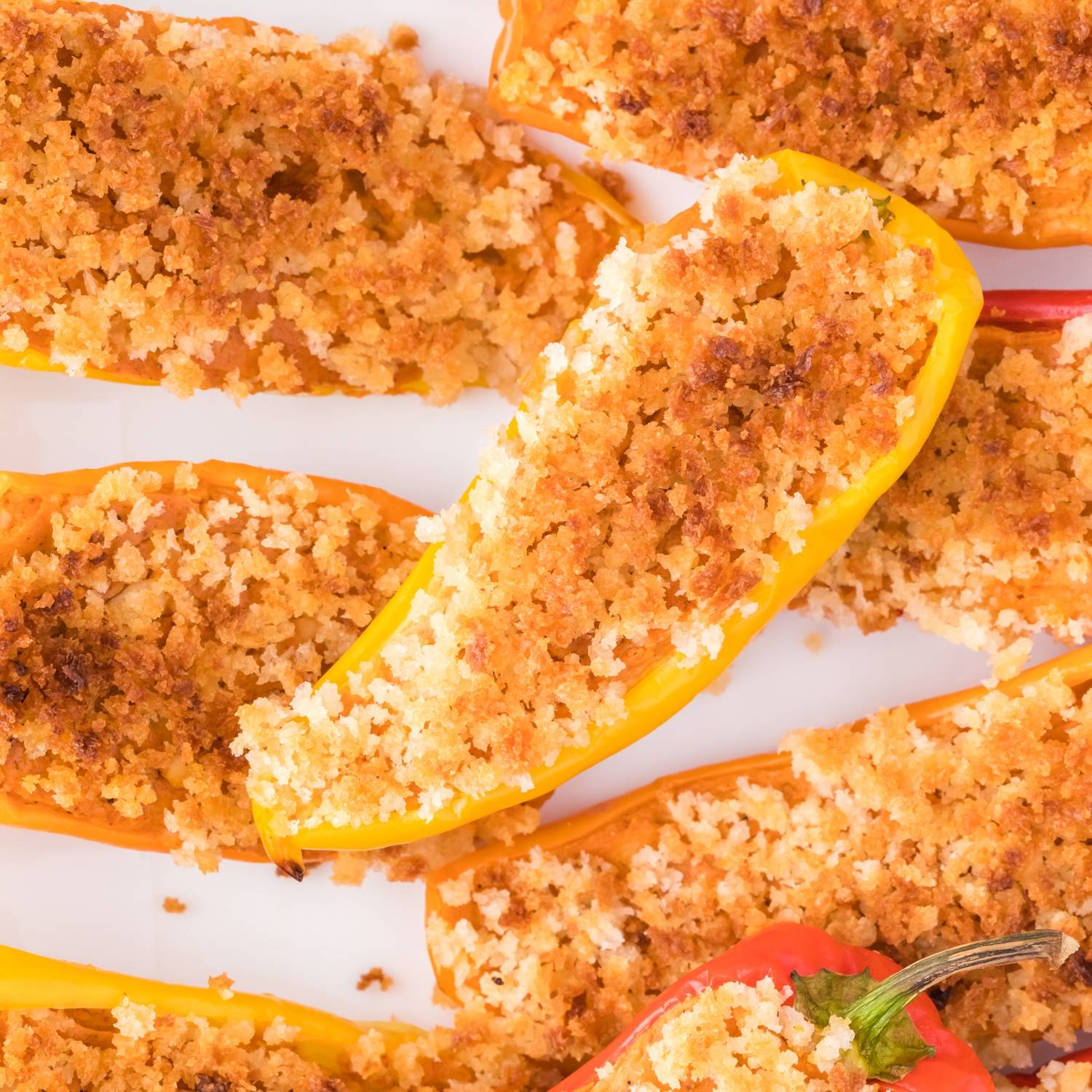 Stuffed mini peppers topped with panko bread crumbs.