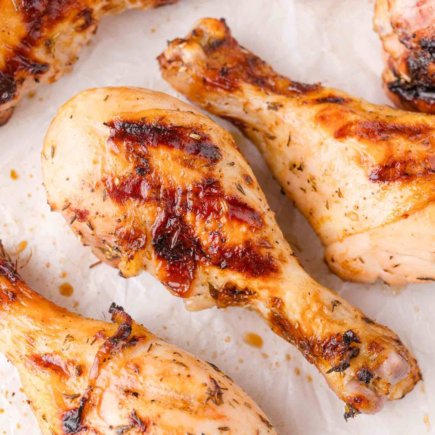 Grilled chicken drumsticks on a white background.