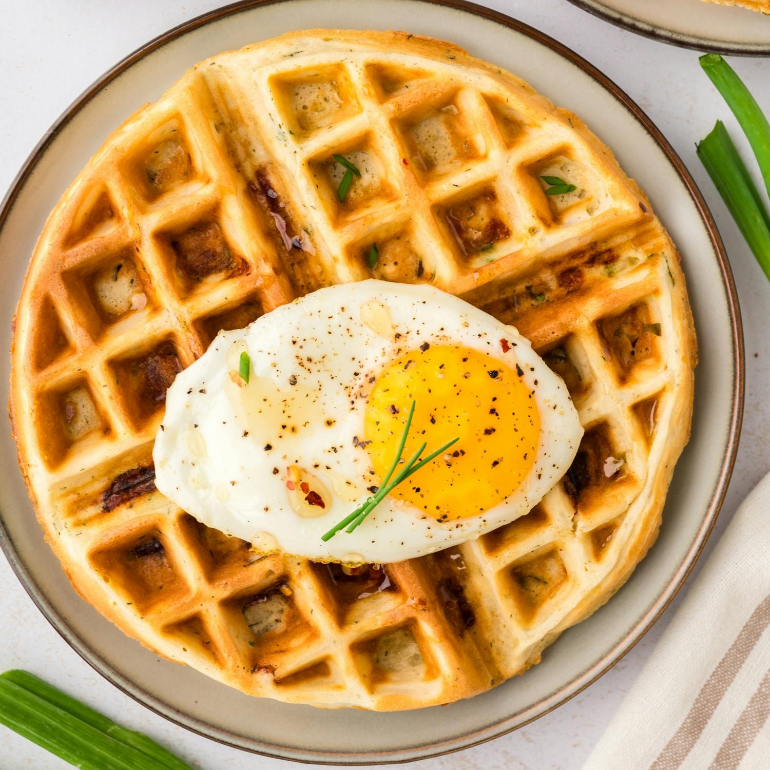 Savory waffle topped with an egg.