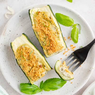 Zucchini, cut in half and stuffed with cheesy mixture and topped with crispy breadcrumbs.