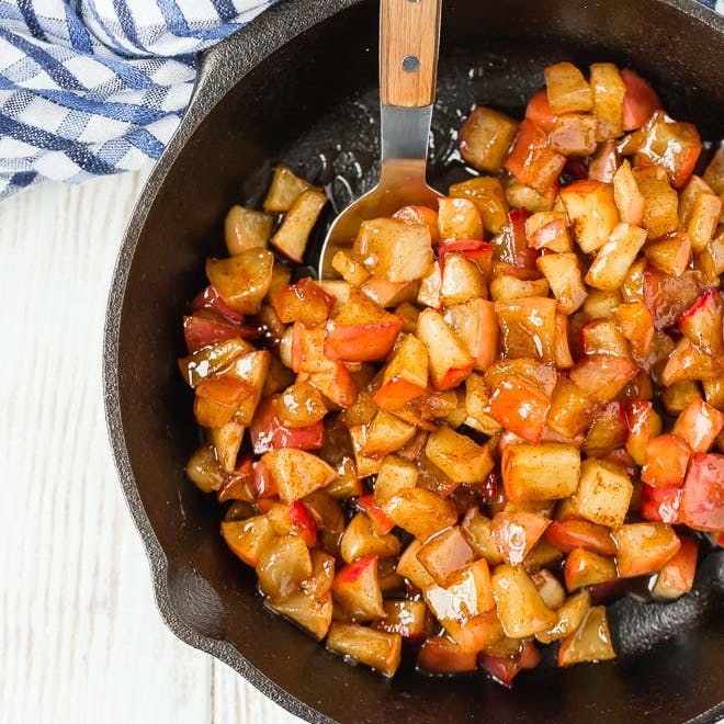 Apple compote in a black skillet.