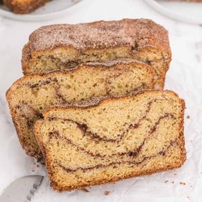 Three slices of snickerdoodle bread, with a cinnamon swirl.