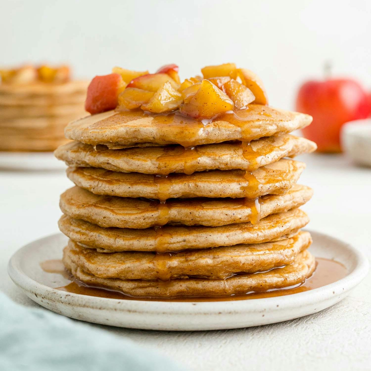 Stack of apple pancakes topped with apple pancakes.