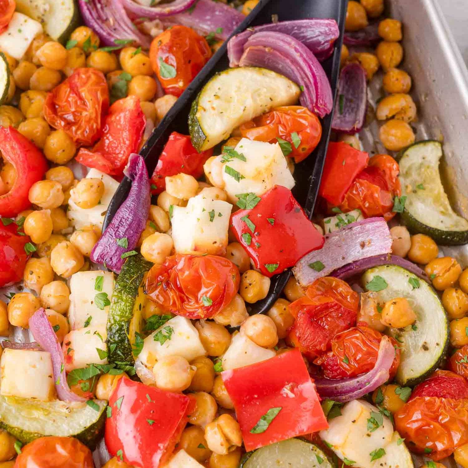 Halloumi, chickpeas, and vegetables on a sheet pan.