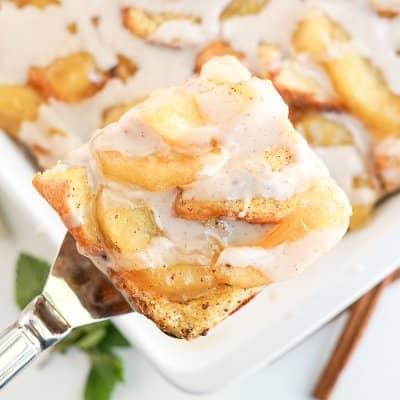 Square of a french toast casserole with apples and glaze.