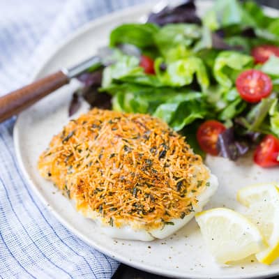 Baked cod on a plate with salad