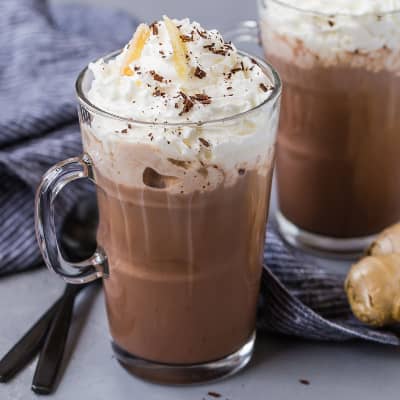 Hot chocolate topped with whipped cream and ginger.