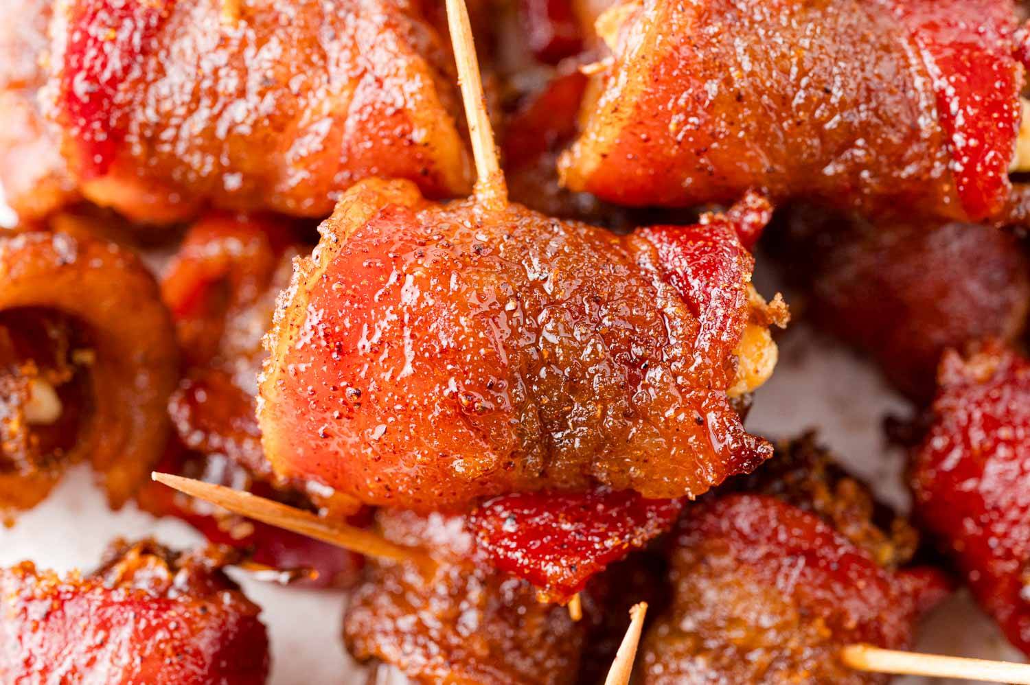 Bacon wrapped dates with toothpicks.