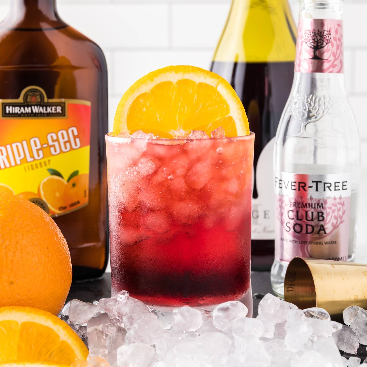 Red wine spritzer garnished with orange.