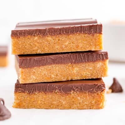Stack of three no bake peanut butter bars.