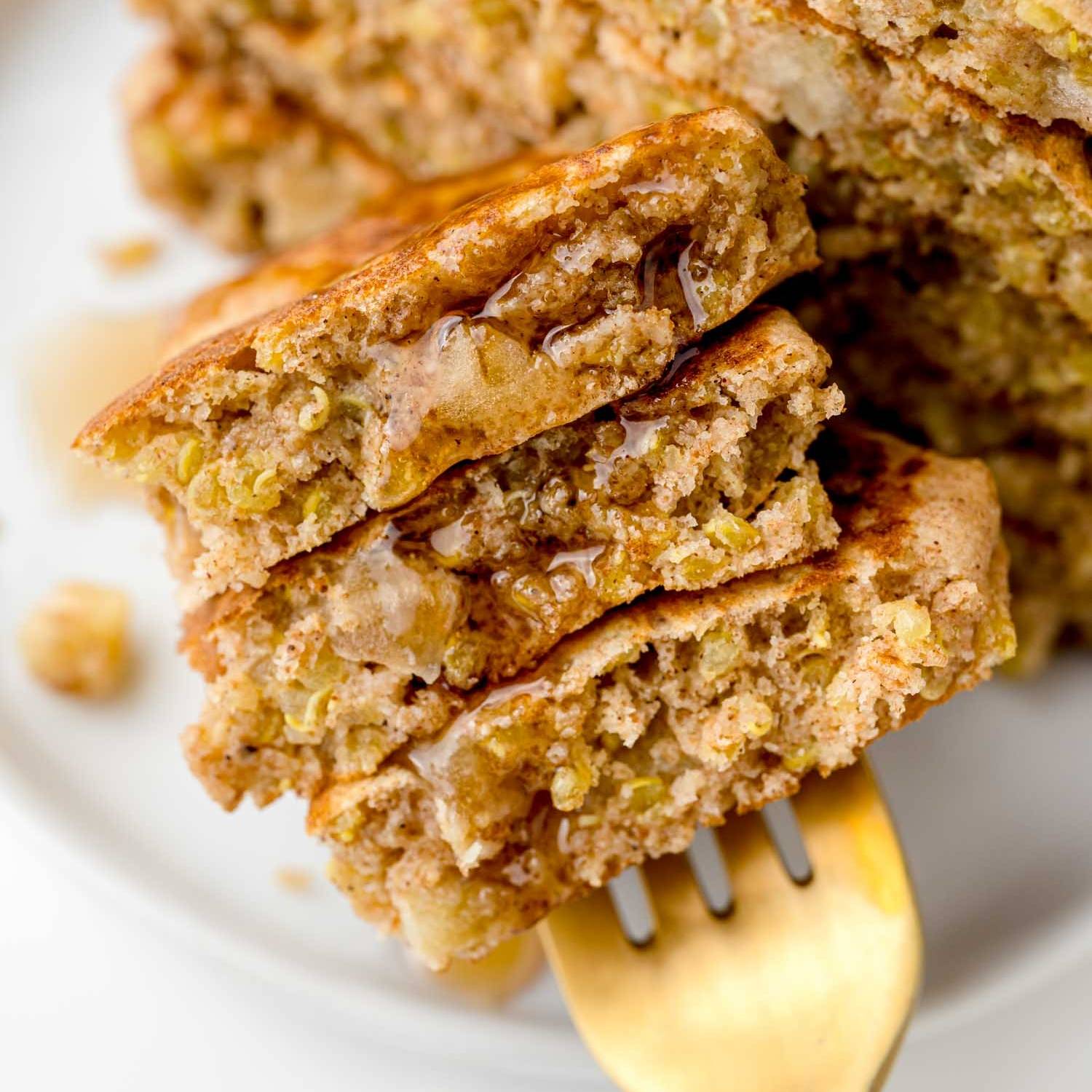 Three pieces of apple quinoa pancakes on a fork.