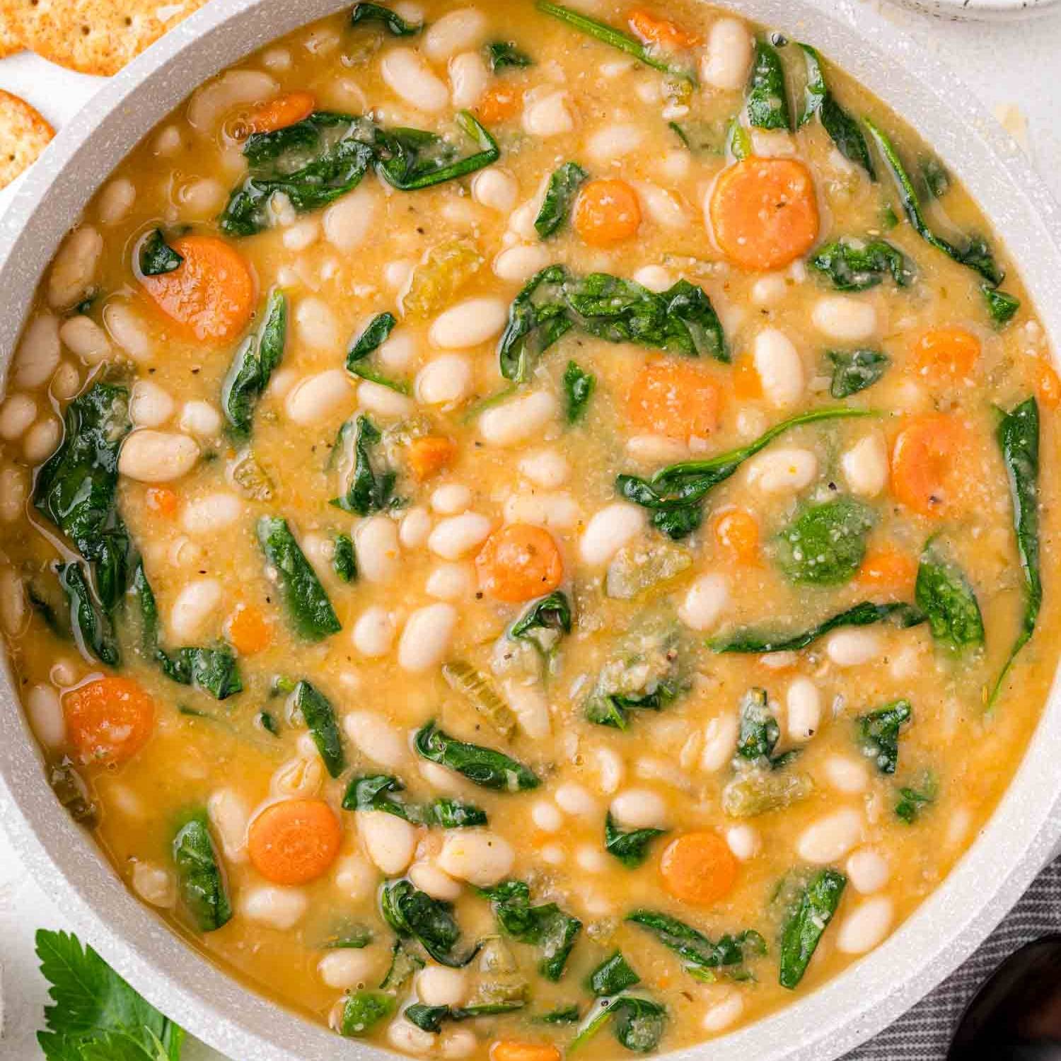 White bean soup with kale, carrots, and a thick broth.