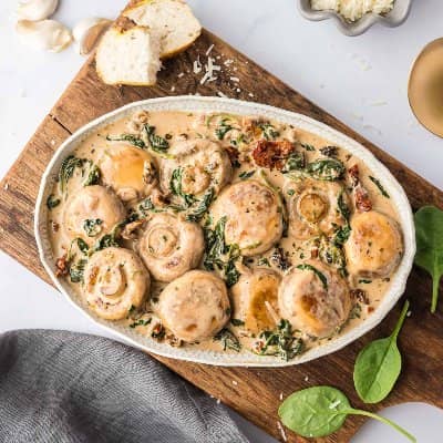 Creamy mushrooms in an oval bowl.