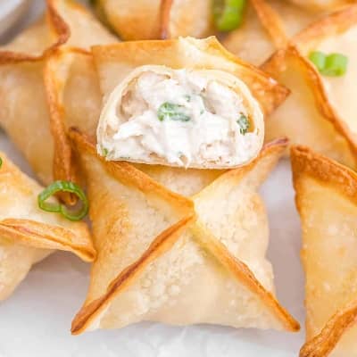 Crab rangoon, one split open to show filling.