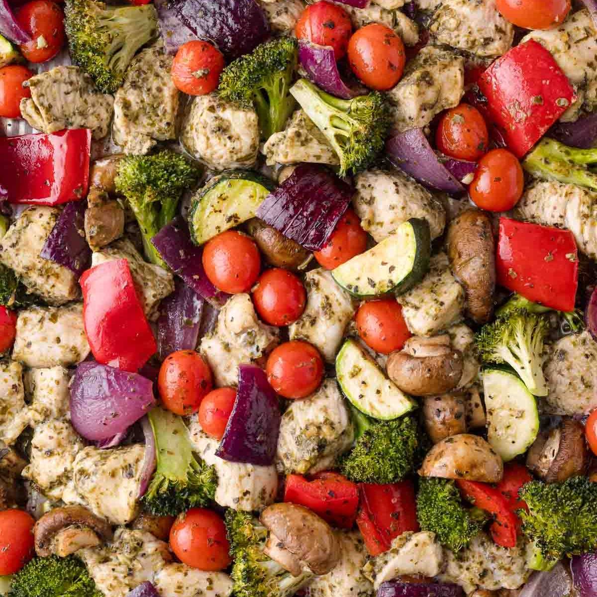 Bite sized chicken with tomatoes, red onions, zucchini, and other vegetables, all tossed a pesto sauce. 
