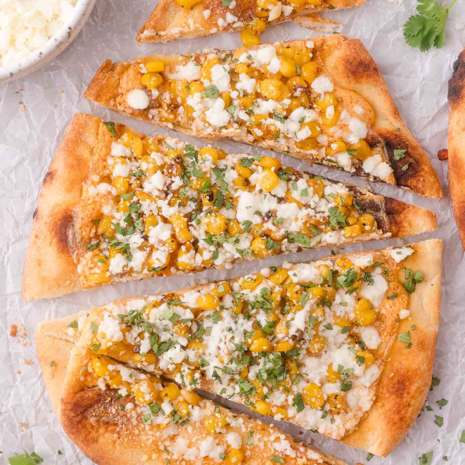 Flatbread with corn, cheese, and cilantro.