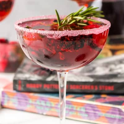 Love potion cocktail garnished with rosemary.