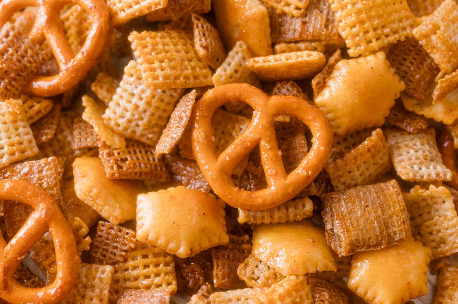 Close up image of hot honey chex mix showing chex cereal, oyster crackers, and pretzels.