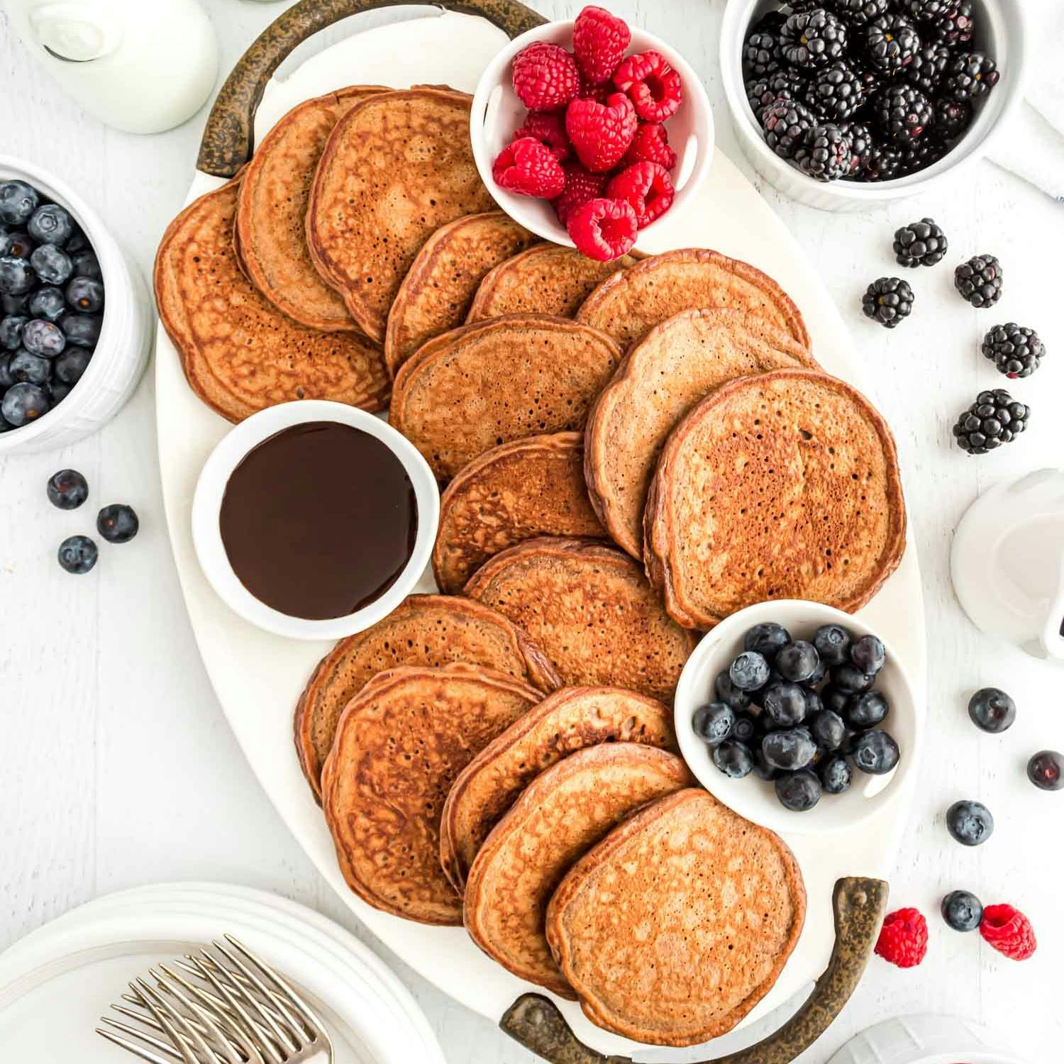 Chocolate protein pancakes on a large platter.