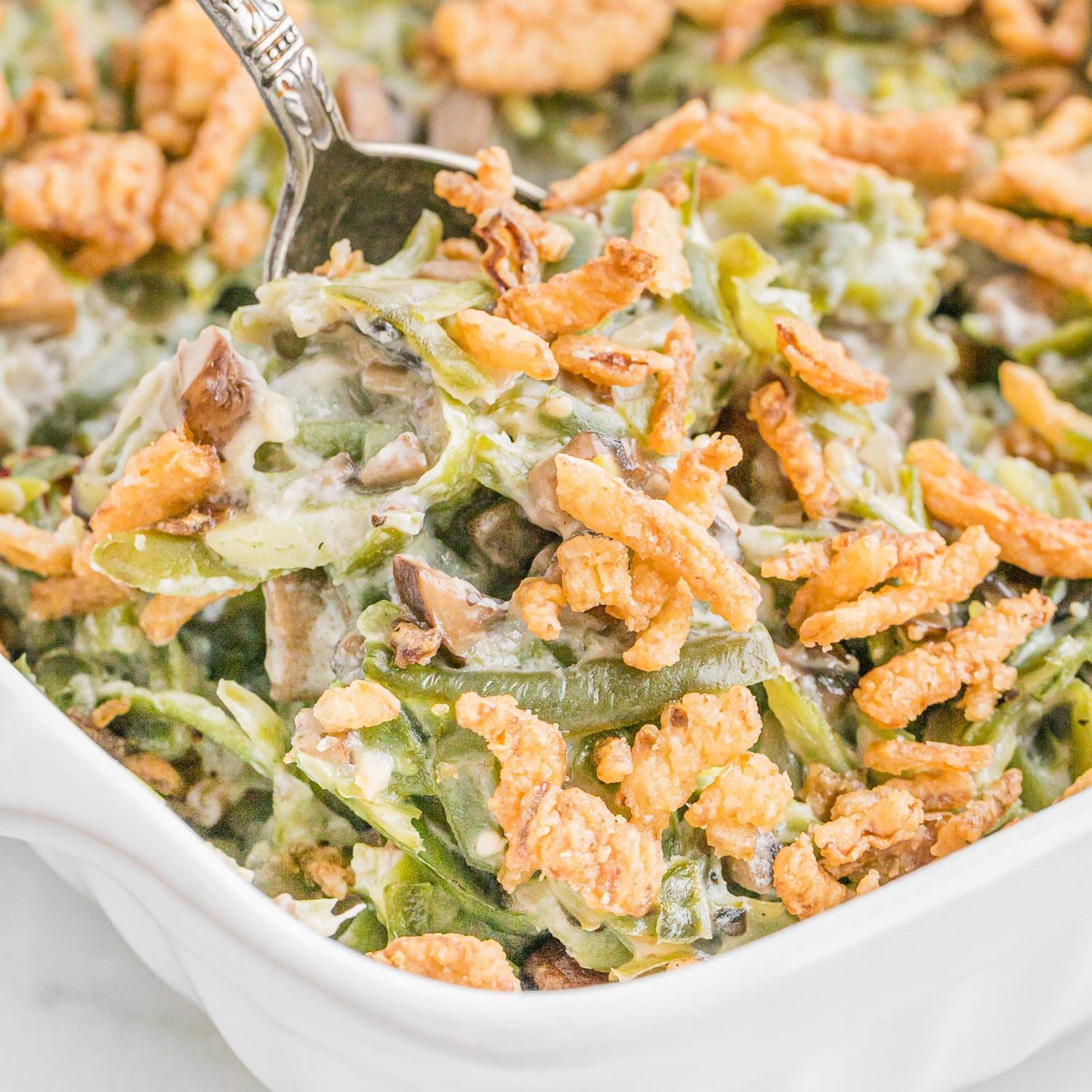 Green bean casserole topped with crispy fried onions.