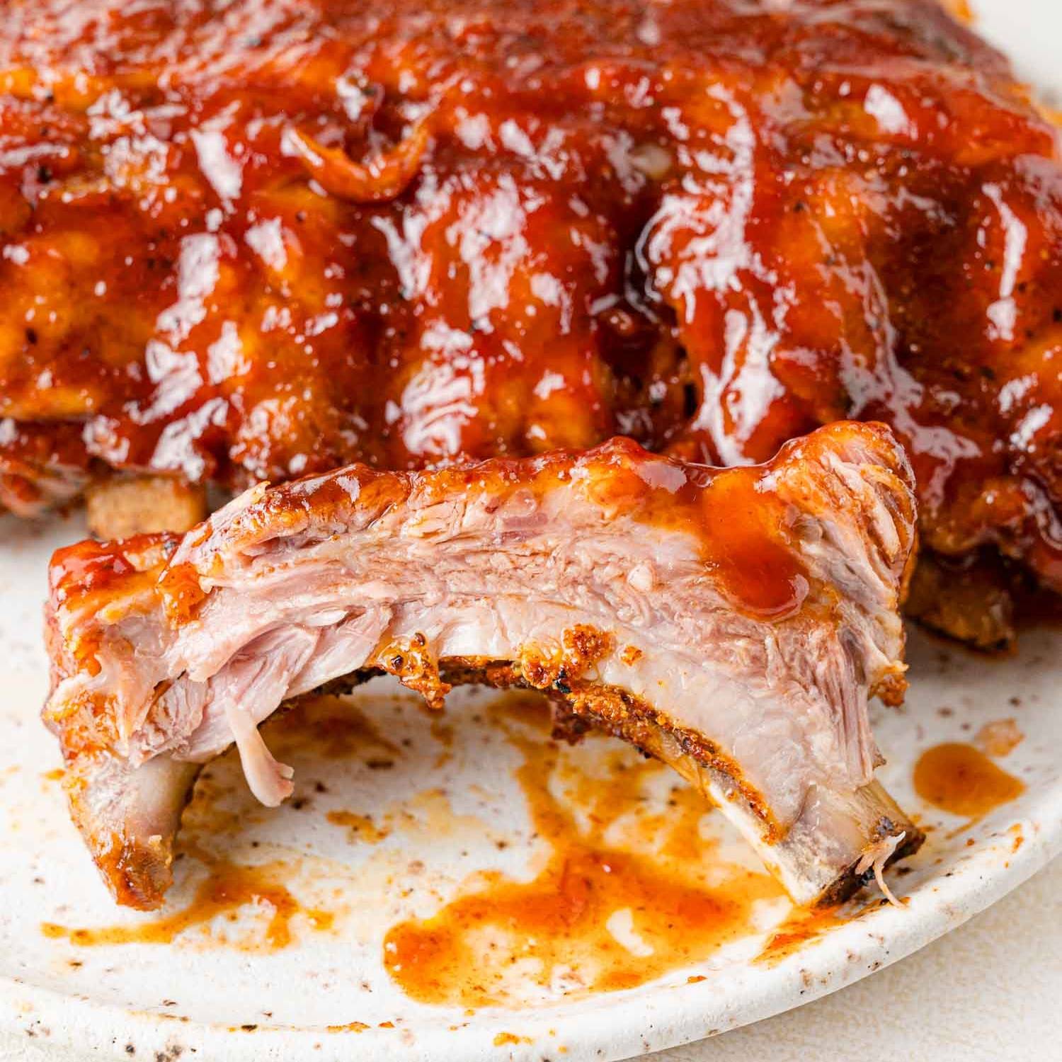 Instant Pot ribs on a speckled plate.