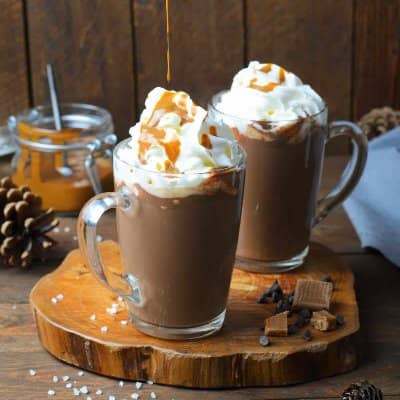 Two mugs of hot chocolate with caramel.