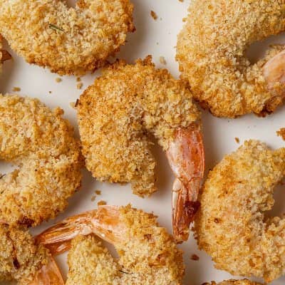 Breaded shrimp on a white surface.