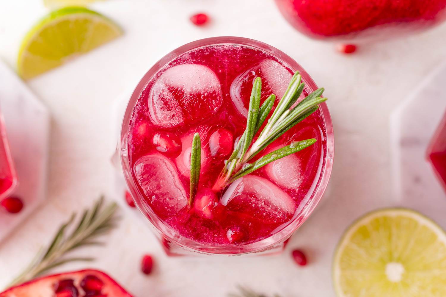 Overhead view of pomegranate rosemary spritzer, garnished with fresh rosemary.