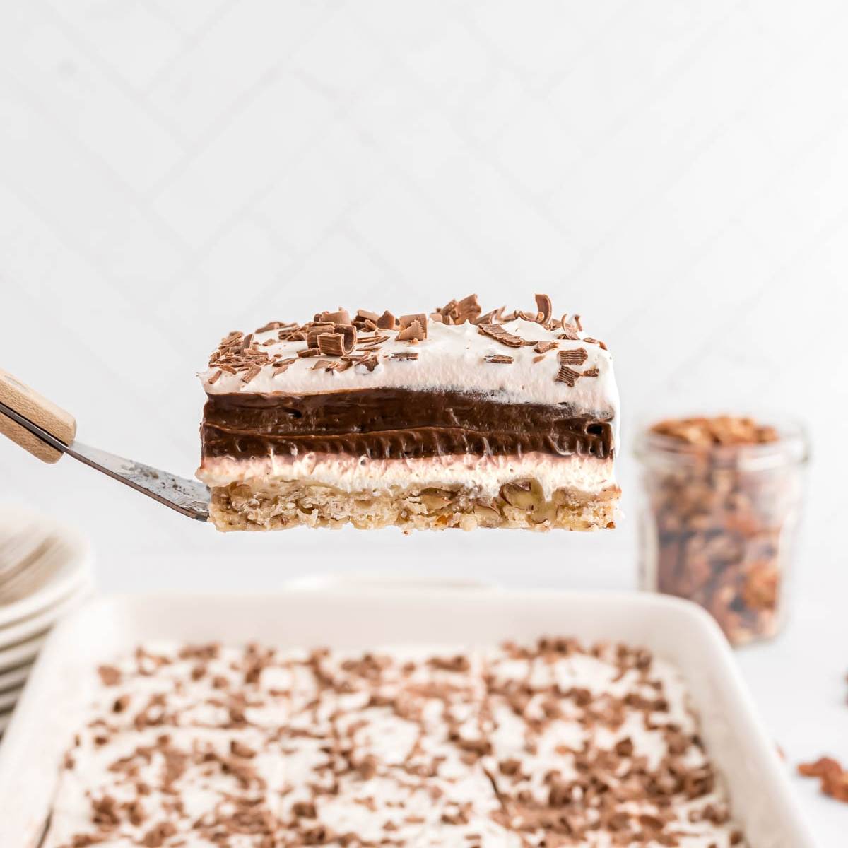 Slice of chocolate delight being lifted from a pan of more.