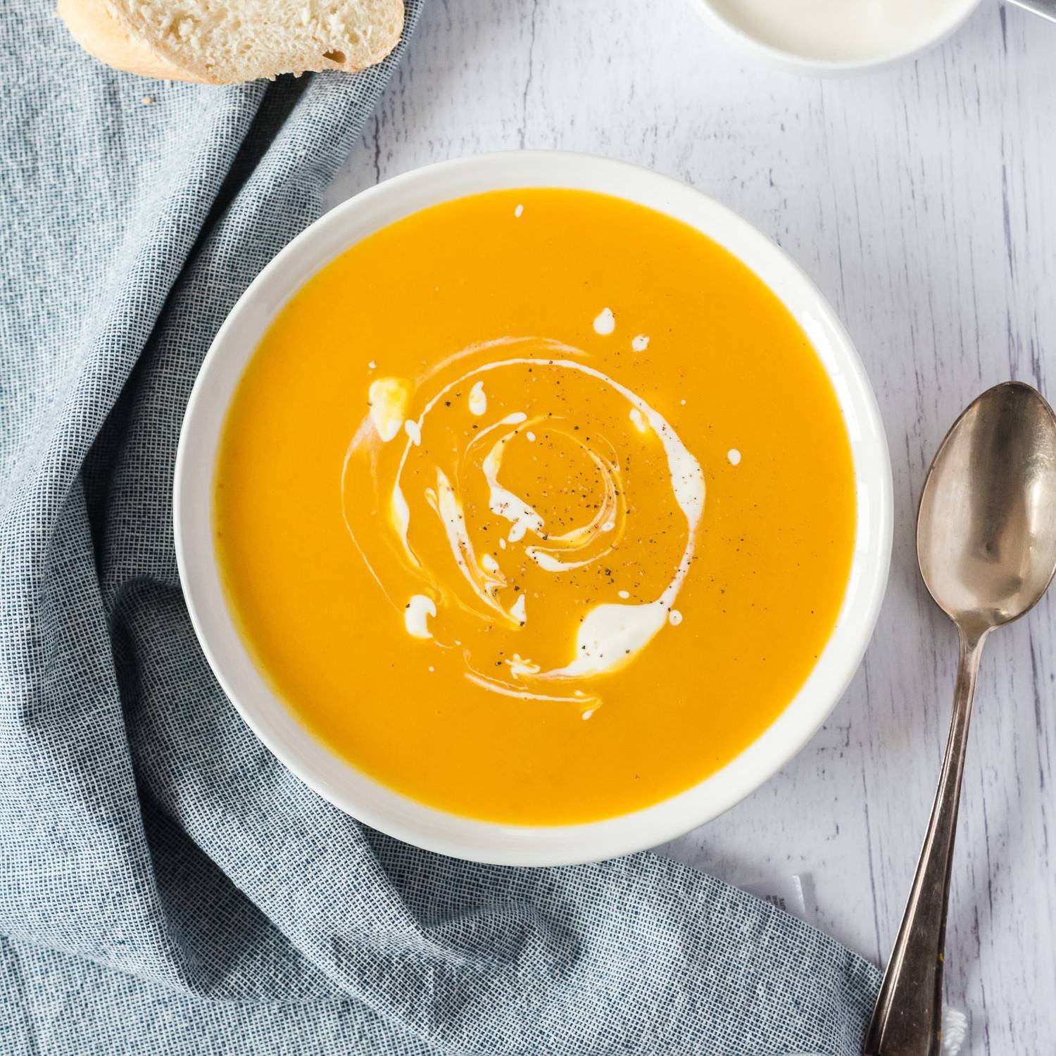 Pumpkin soup swirled with cream.