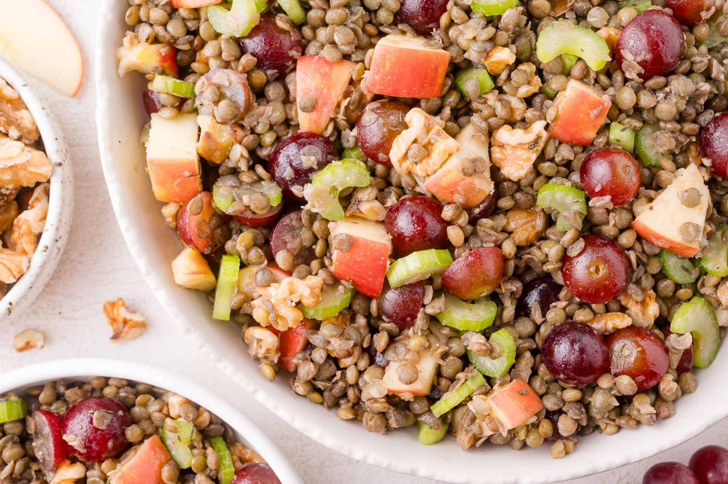 Lentil waldorf salad with green lentils, apples, celery, grapes, and walnuts.