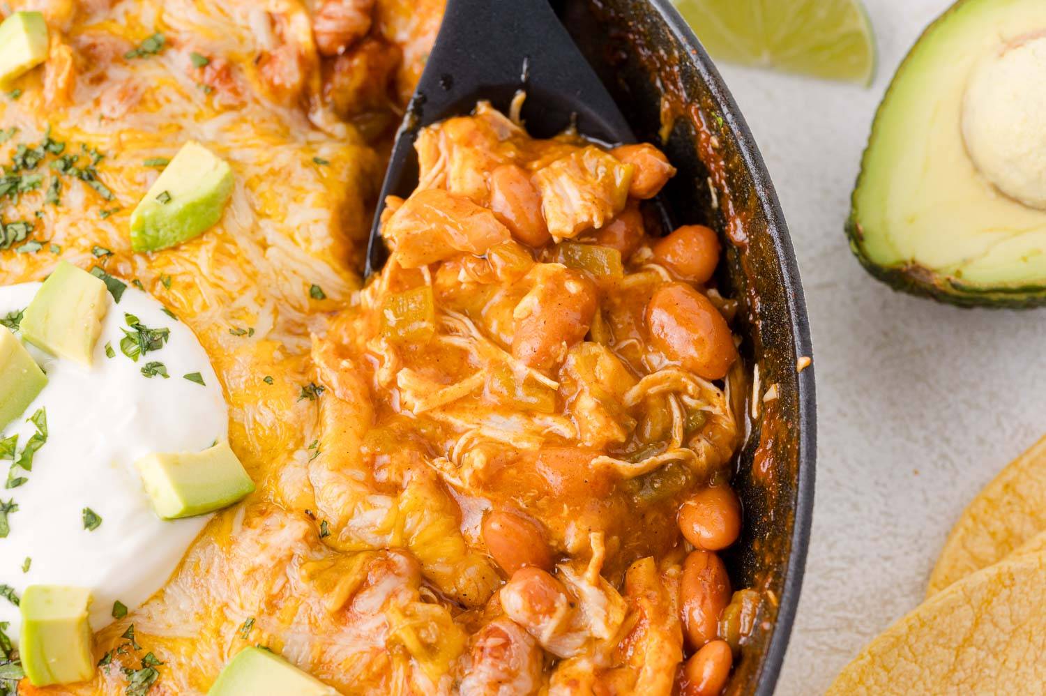Chicken enchilada skillet with a spoon in it.