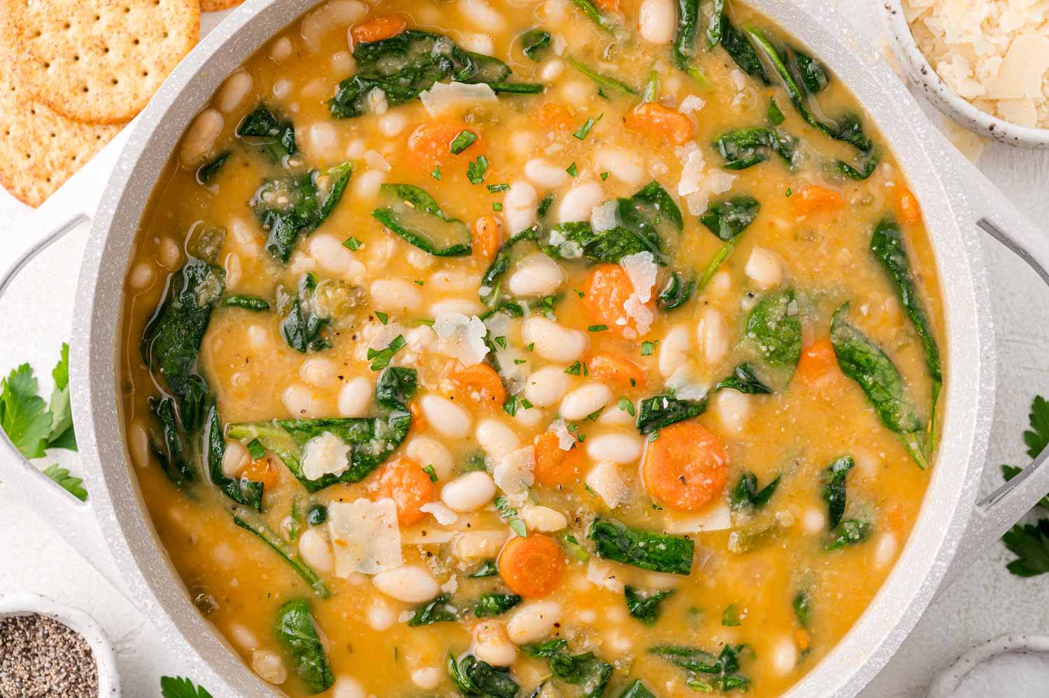 White bean soup with spinach and carrots.