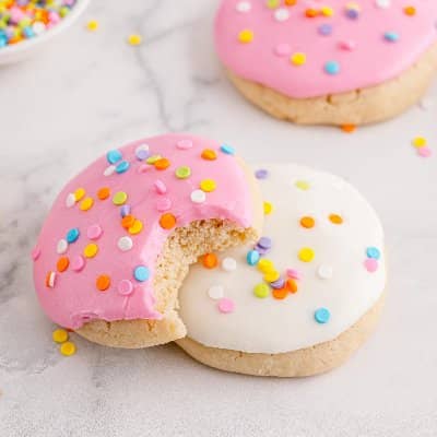 Pink and white cookies with sprinkles.