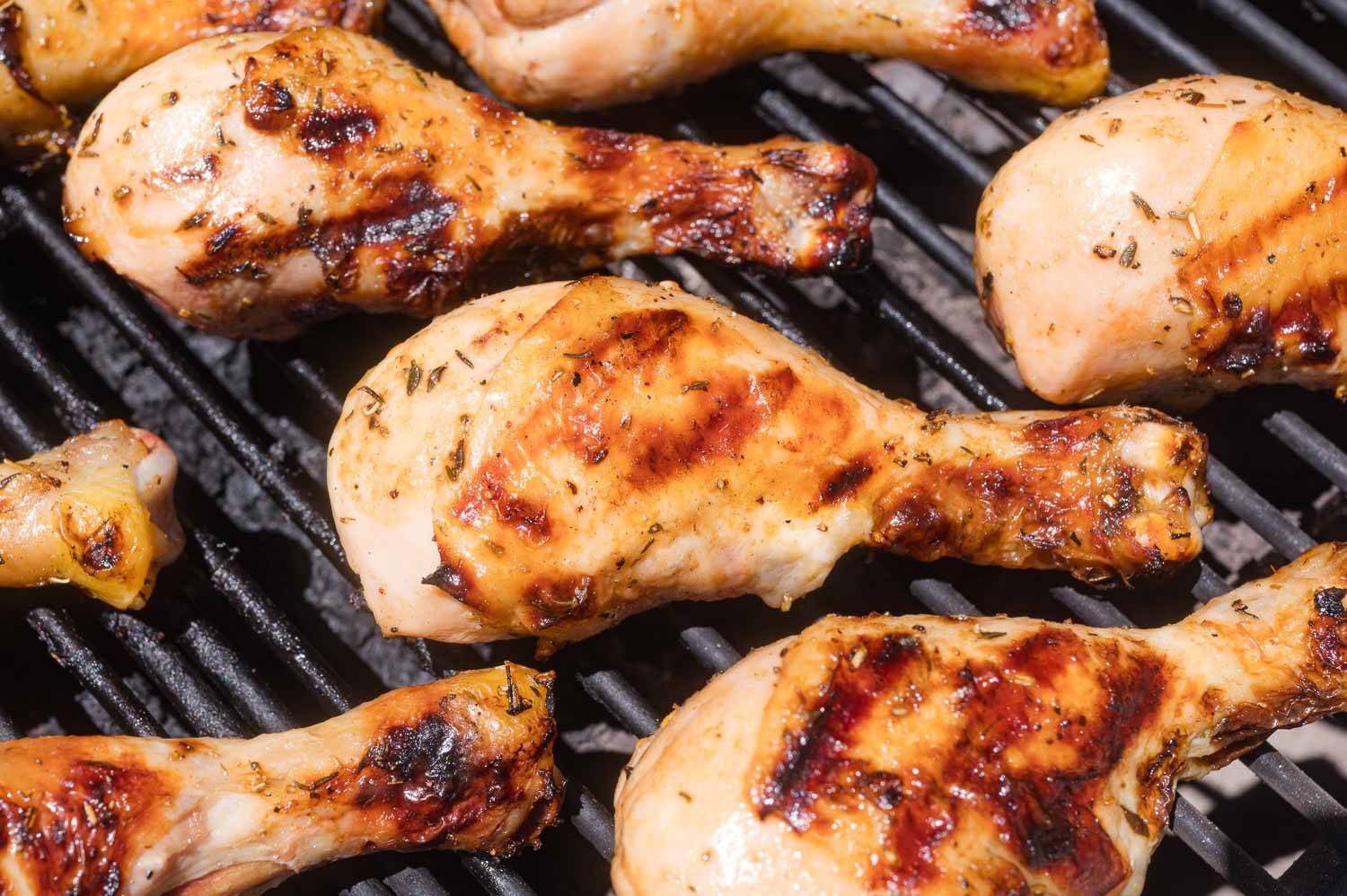 Chicken drumsticks on a grill.