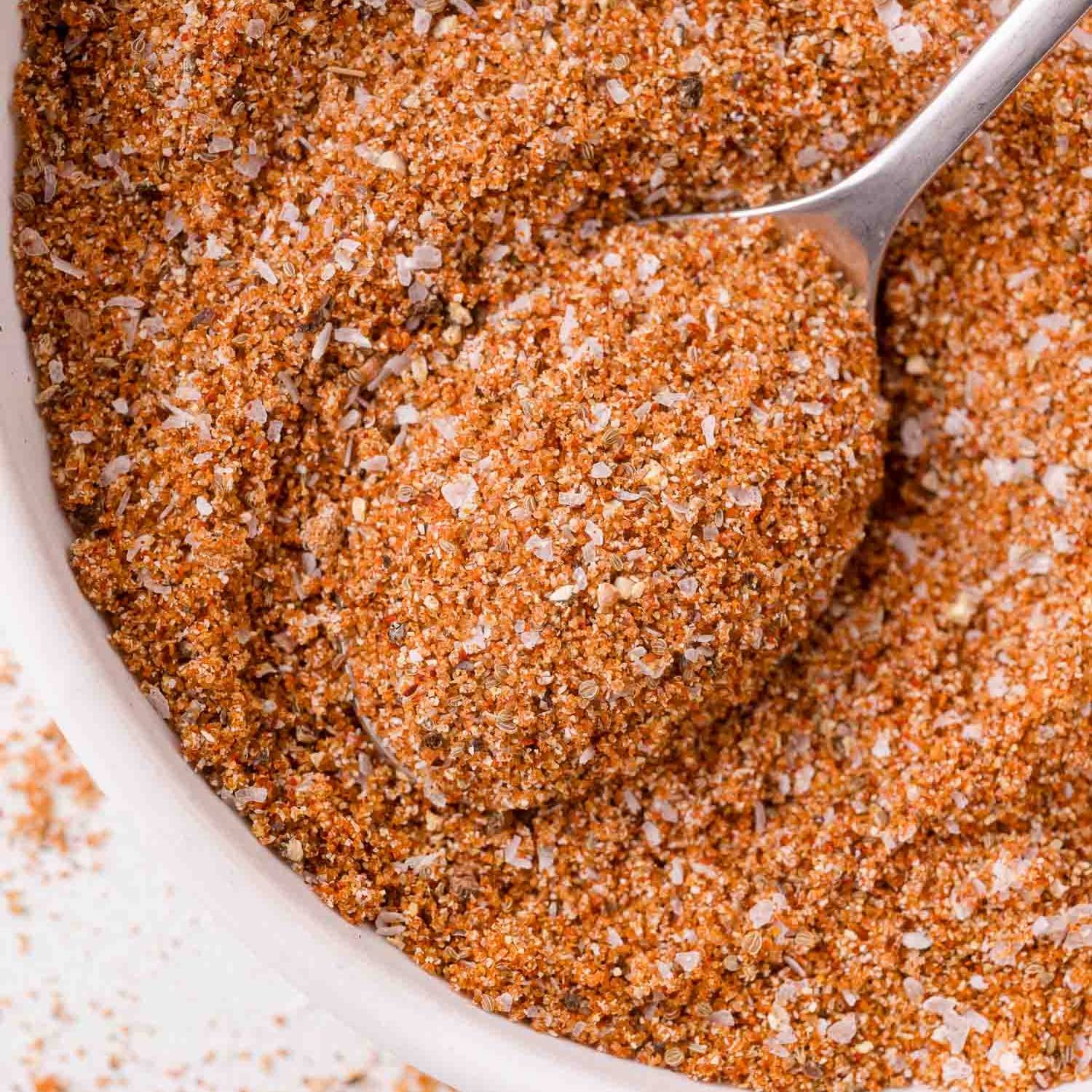 Barbecue rub in a bowl, with a spoon.