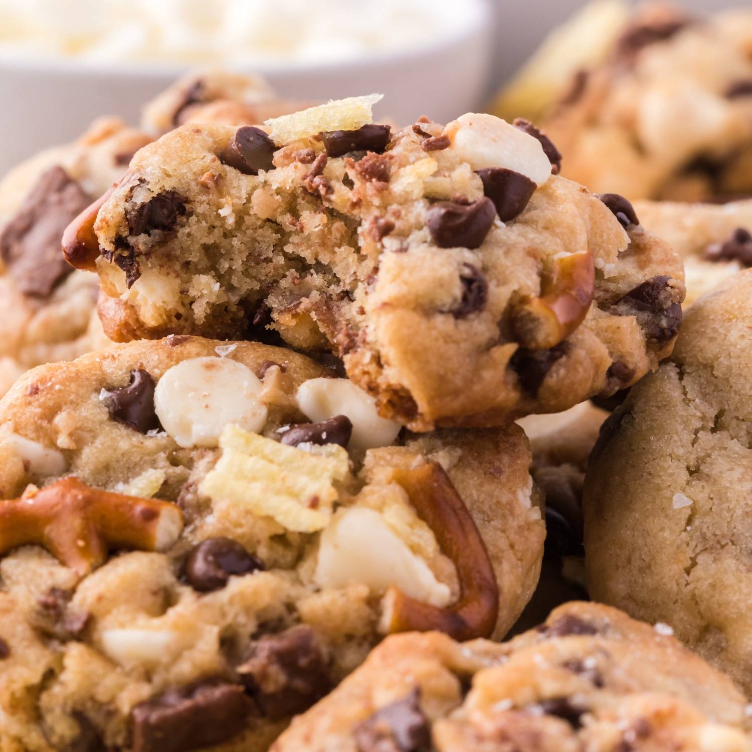 Close up of cookies with pretzels, chocolate, ad potato chips in them.