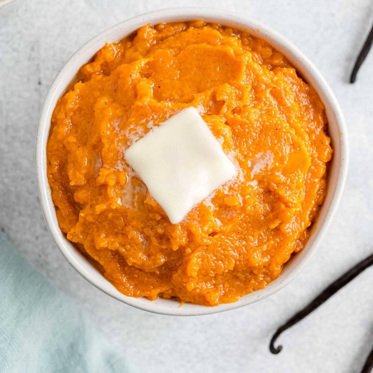 Vanilla bean mashed sweet potatoes topped with butter.