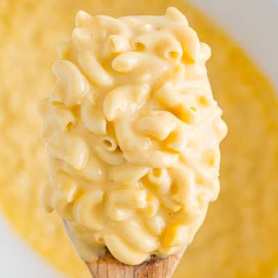 Crockpot mac and cheese on spoon.